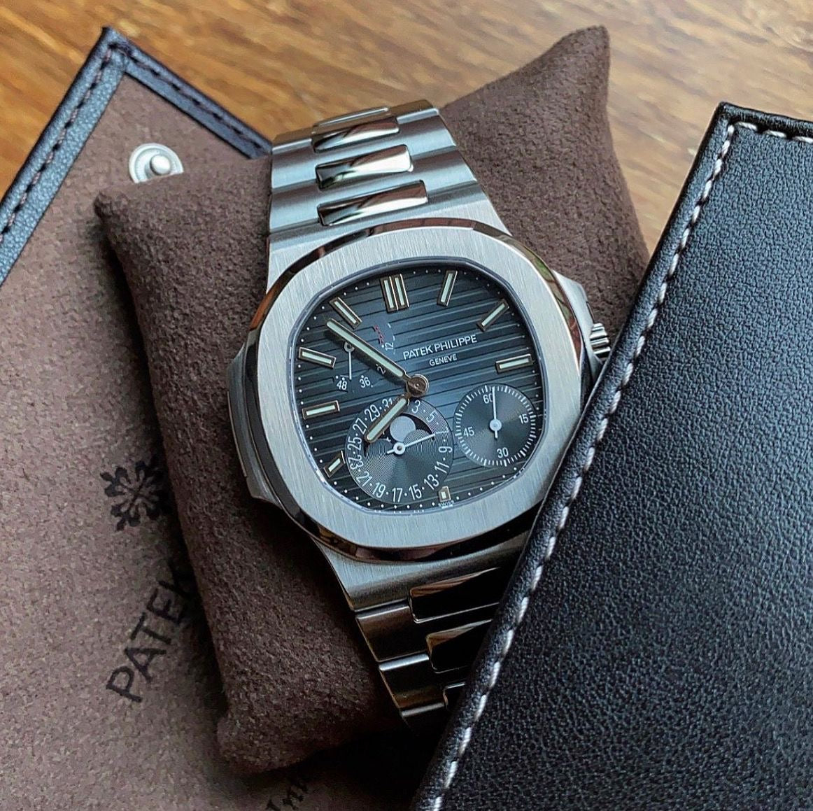 Patek Philippe Nautilus 2017 Ref. 5712/1A-001 - Official Service Papers from 2020 Regal - Hatton Garden Jewellers