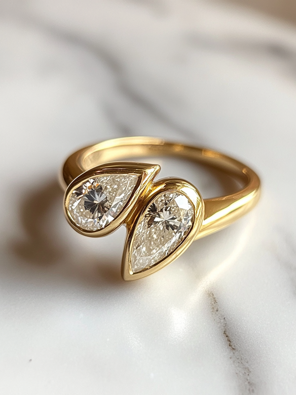 Gold ring with two teardrop-shaped diamond