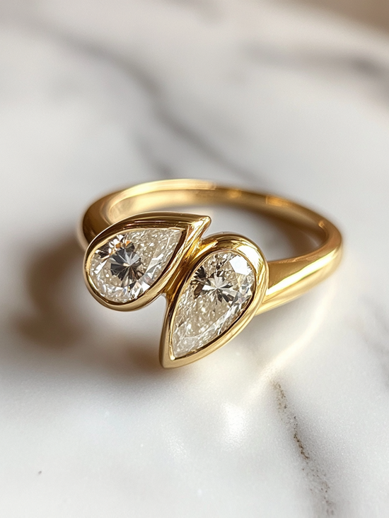 Gold ring with two teardrop-shaped diamond